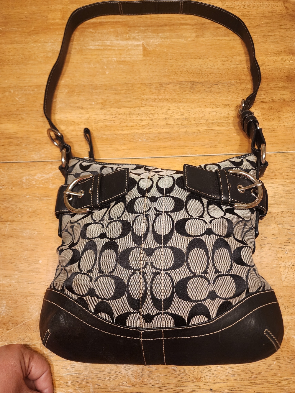 Coach Soho Signature Buckle Shoulder Bag crafted in a black and grey signature